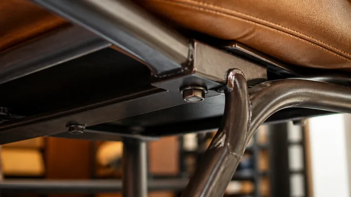 Close detail of a commercial chair joint and steel frame underside