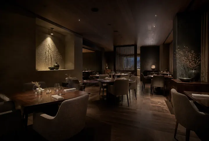 Fine dining tasting room with widely spaced tables, low light levels and generous service aisles