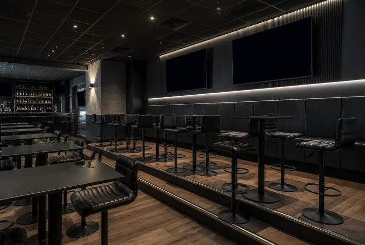 Sports bar dining room laid out so every seat holds a sightline to the screens above the bar